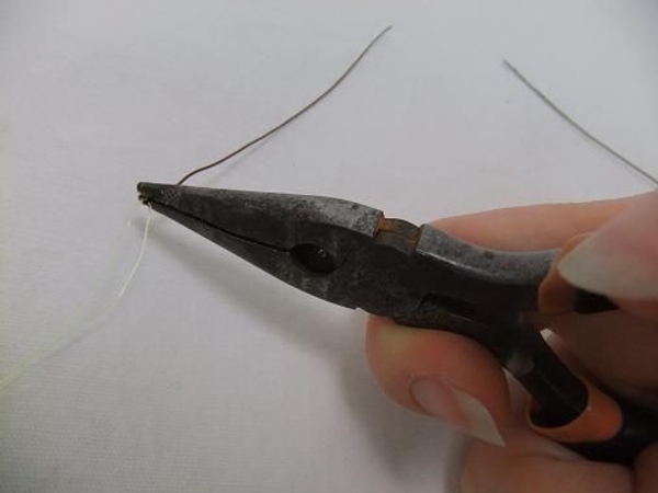 Bend a tiny hairpin loop in the top end of the wire. Bend a tiny hairpin loop in the top end of the wire.