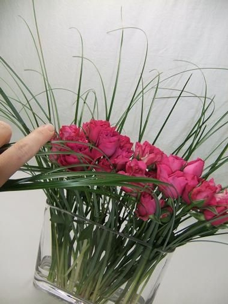 Comb the grass with your hand in the direction the french braid will be. Comb the grass with your hand in the direction the french braid will be.