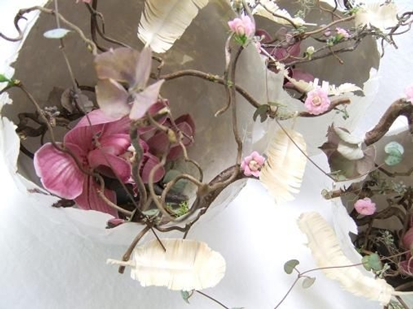 Cymbidium orchids tucked low into hatched Papier Mache Easter eggs. Cymbidium orchids tucked low into hatched Papier Mache Easter eggs.