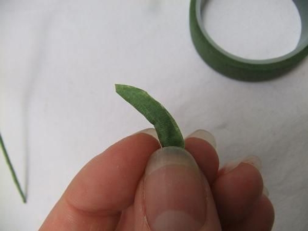 Fold the florist tape closed and shape it gently into a pod Fold the florist tape closed and shape it gently into a pod