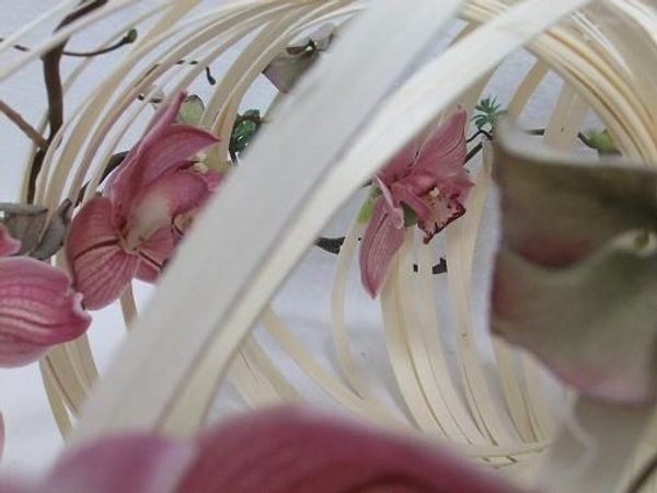 Glue small test tubes into the structure for the orchids Glue small test tubes into the structure for the orchids