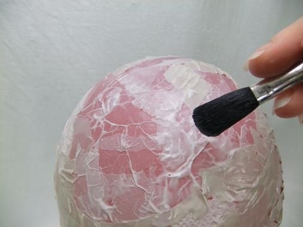 Paint the paper with glue and smooth out any bubbles. Paint the paper with glue and smooth out any bubbles.
