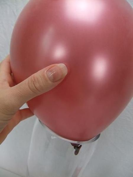 Place the balloon in a heavy vase. Place the balloon in a heavy vase.