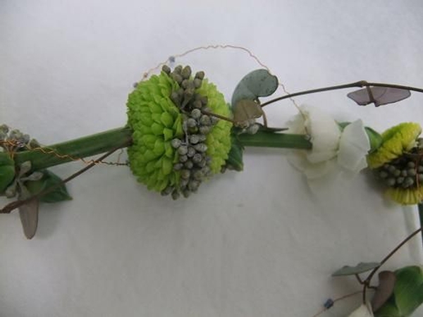 Rosary vine, wire and beads decorate the floral lariat necklace. Rosary vine, wire and beads decorate the floral lariat necklace.