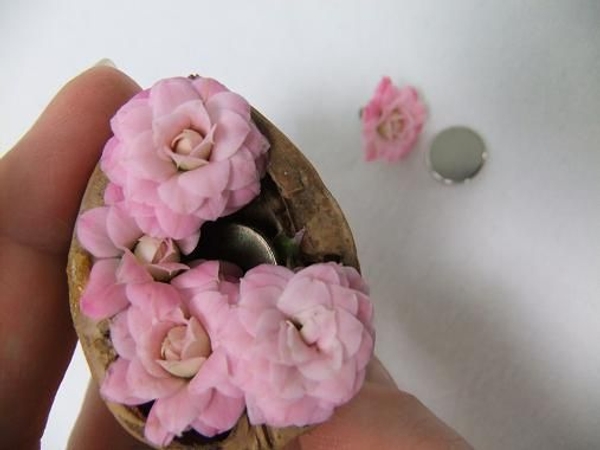 Tuck the thinest part of a corsage magnet into a nutshell. Tuck the thinest part of a corsage magnet into a nutshell.