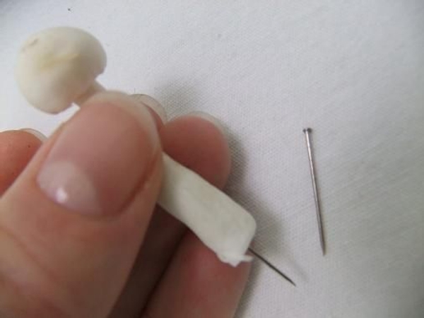 Use a pin to skewer smaller mushrooms. Use a pin to skewer smaller mushrooms.