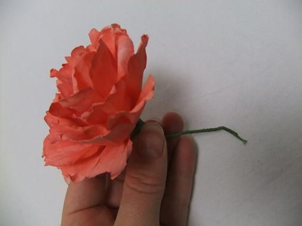 Wire the paper carnation and tape it with florist tape Wire the paper carnation and tape it with florist tape