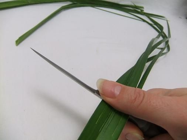 Run the back of your knife along the leaf to make it pliable Run the back of your knife along the leaf to make it pliable