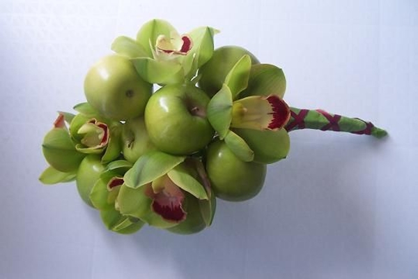 Wire the apples to create an armature for the orchids. Wire the apples to create an armature for the orchids.