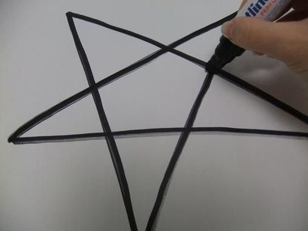 Draw the star shape on cardboard with a marker. Draw the star shape on cardboard with a marker.