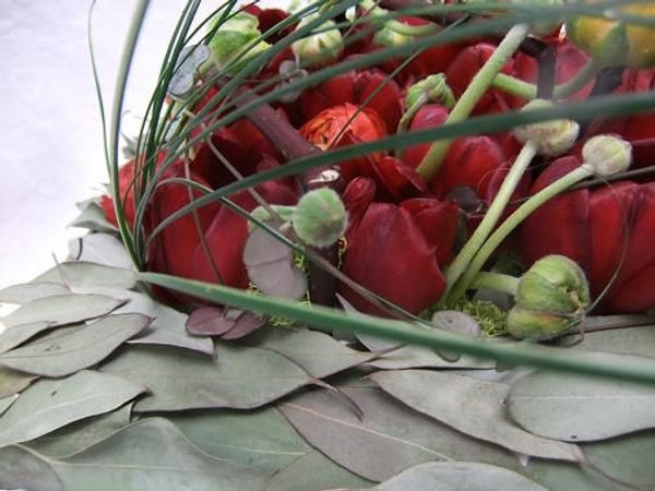 Hang test tubes and fill the grid with a pave of mixed flowers.