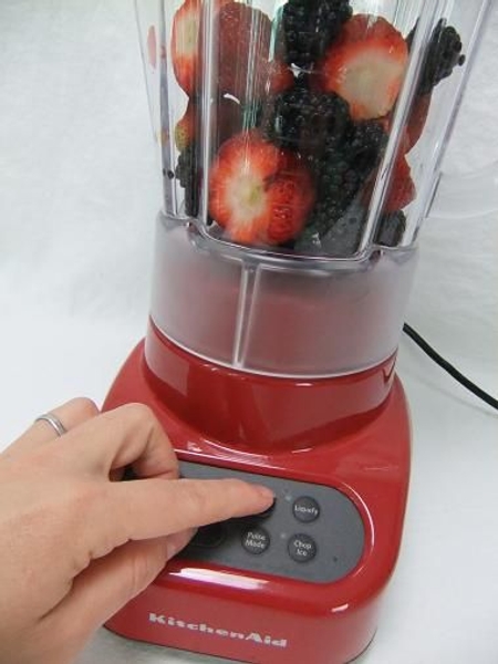 Place the berries in a blender. Place the berries in a blender.
