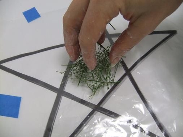 Place the sticky mixture on the plastic star. Place the sticky mixture on the plastic star.