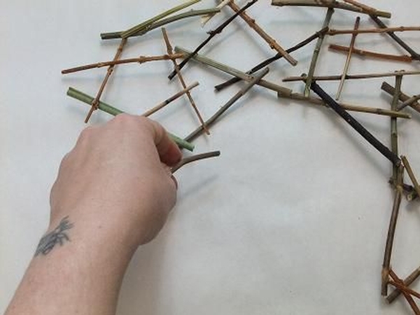 Continue to glue twigs in a round shape. Continue to glue twigs in a round shape.