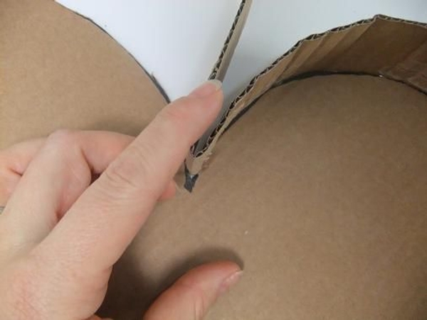 Fold the cardboard to create a sharp v at the top.jpg Fold the cardboard to create a sharp v at the top.jpg