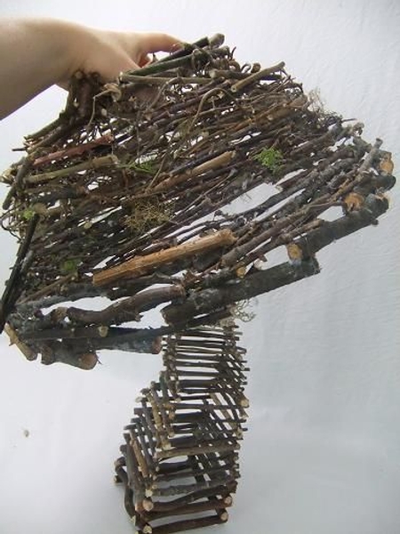 Place the twig cap on the mushroom. Place the twig cap on the mushroom.