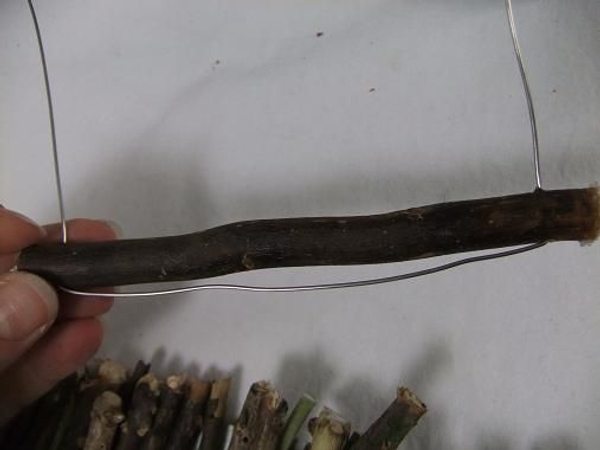 Press the wire flat at the bottom of the side of the twig. Press the wire flat at the bottom of the side of the twig.