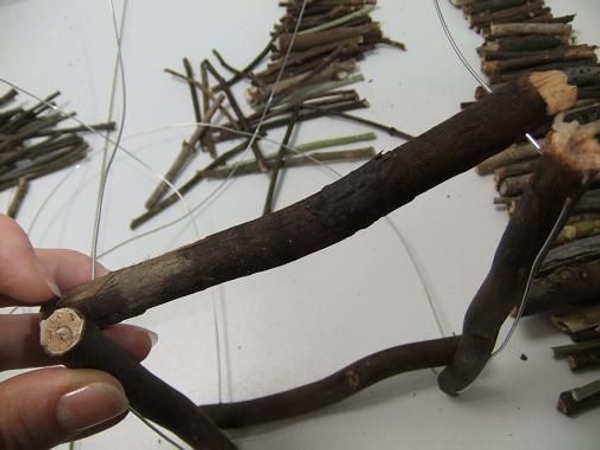 Start building up the base by threading in twigs. Start building up the base by threading in twigs.