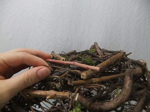 Weave a few twigs into the design to create a load bearing surface. Weave a few twigs into the design to create a load bearing surface.