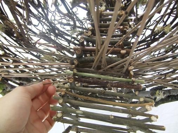 Weave some of the Mikado reeds to go over and under other reeds to secure the structure. Weave some of the Mikado reeds to go over and under other reeds to secure the structure.