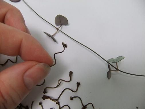 Wrap twigs around a skewer to create spirals. Wrap twigs around a skewer to create spirals.