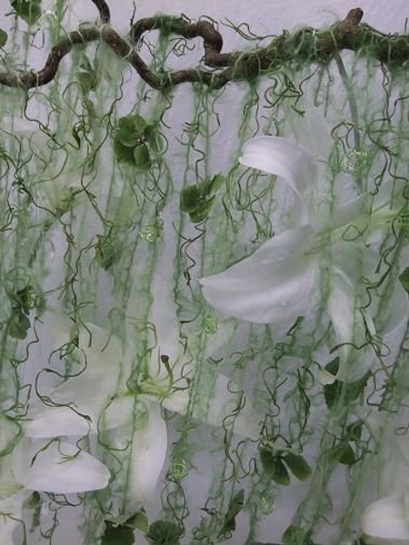 A veil of green wool rains over the design. A veil of green wool rains over the design.