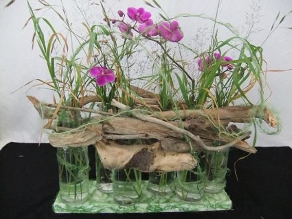 Driftwood nestles onto the glass bottles.