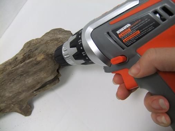 Drill a hole in the bottom of the driftwood. Drill a hole in the bottom of the driftwood.