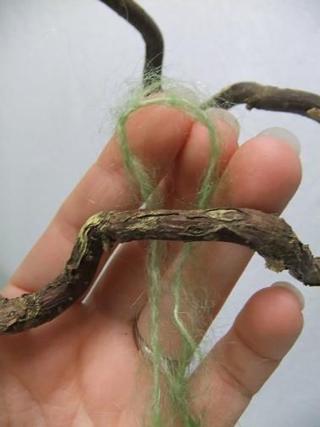 Fold the wool in half. Fold the wool in half.