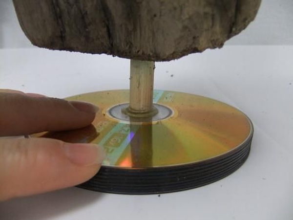 Glue the driftwood to sit on the CD stack Glue the driftwood to sit on the CD stack