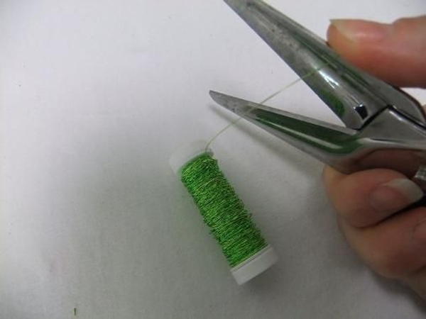Pull the wire between the scissors and your thumb as if to curl ribbon. Pull the wire between the scissors and your thumb as if to curl ribbon.