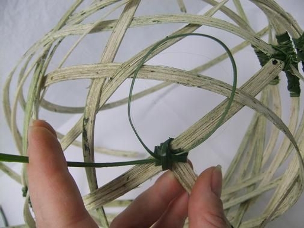 Tie a shorter section of cane to the two bottom cane pieces. Tie a shorter section of cane to the two bottom cane pieces.