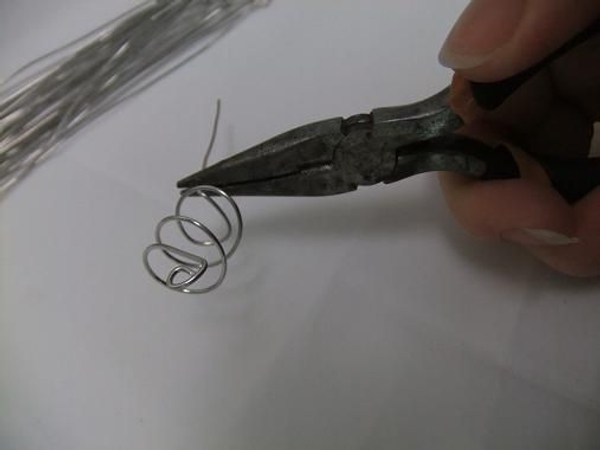 Fold the bottom wire flat and in to create a base. Fold the bottom wire flat and in to create a base.