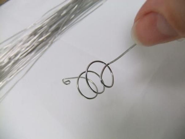 Make sure the top spiral points out and the bottom wire covers the opening. Make sure the top spiral points out and the bottom wire covers the opening.