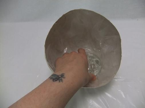 Place the soaked block of Oasis or Kenzan in the plastic in the container. Place the soaked block of Oasis or Kenzan in the plastic in the container.