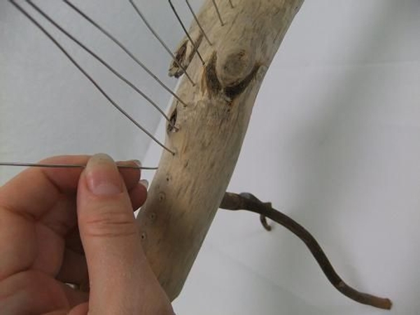 Press the spikes into the wood. Press the spikes into the wood.