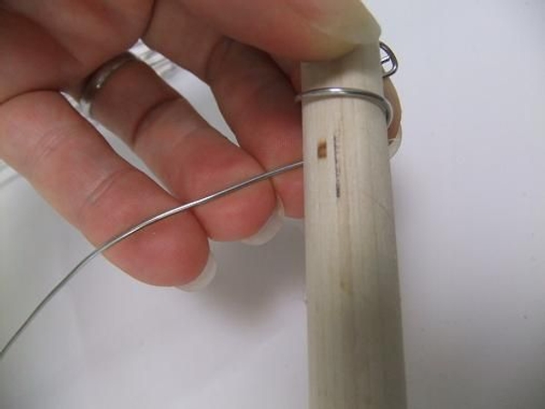 Wrap the wire tightly around the dowel stick. Wrap the wire tightly around the dowel stick.