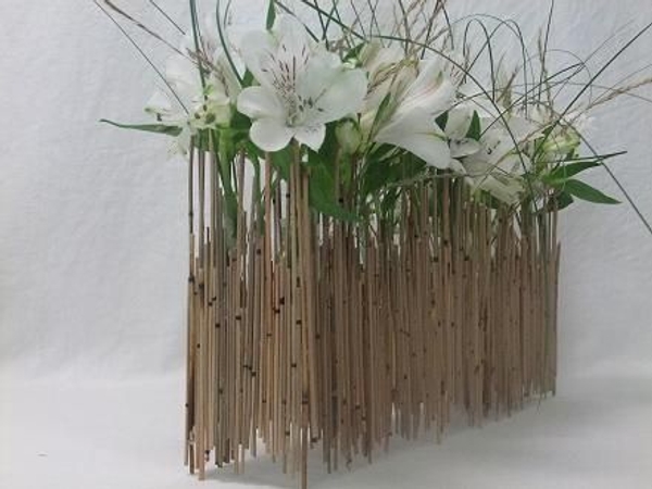 Alstroemeria and grass in a Mikado reed armature. Alstroemeria and grass in a Mikado reed armature.
