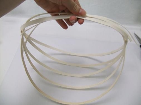 Fold the long dangling coils in and over the basket. Fold the long dangling coils in and over the basket.