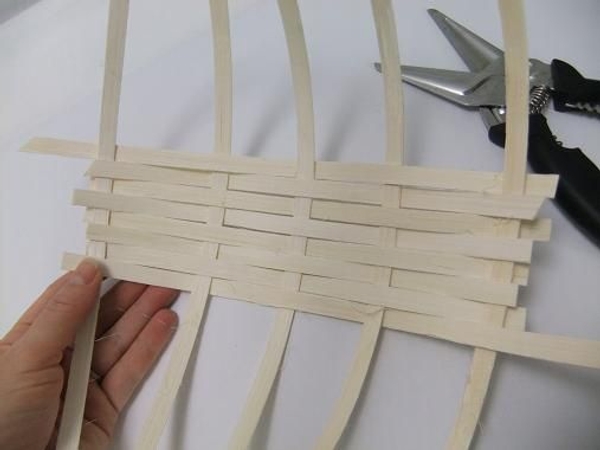 Weaving the cane coil basket. Weaving the cane coil basket.