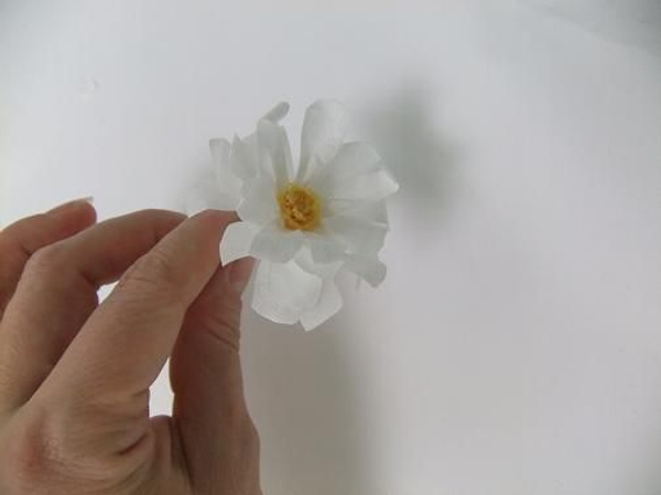 Wrap the white petals around twice for more petals. Wrap the white petals around twice for more petals.