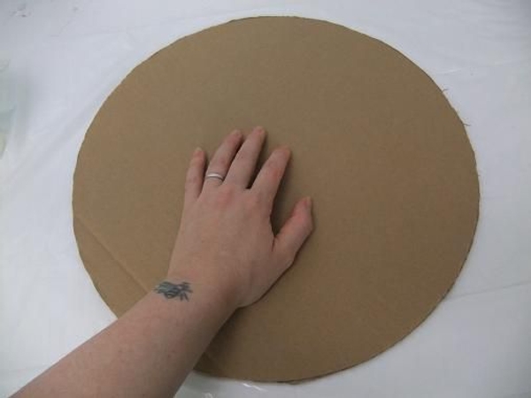 Cut a large cardboard circle. Cut a large cardboard circle.