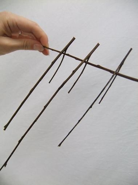 Cut a twig with a fork in it for each lantern to create a natural hook Cut a twig with a fork in it for each lantern to create a natural hook