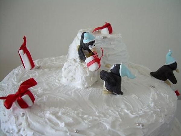 Fondant penguins stacking gifts. Fondant penguins stacking gifts.