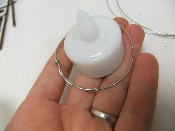 Make two rings from the bale wire for each twig lantern Make two rings from the bale wire for each twig lantern
