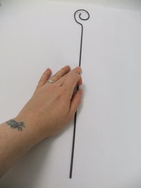 Place the wire on a flat surface Place the wire on a flat surface