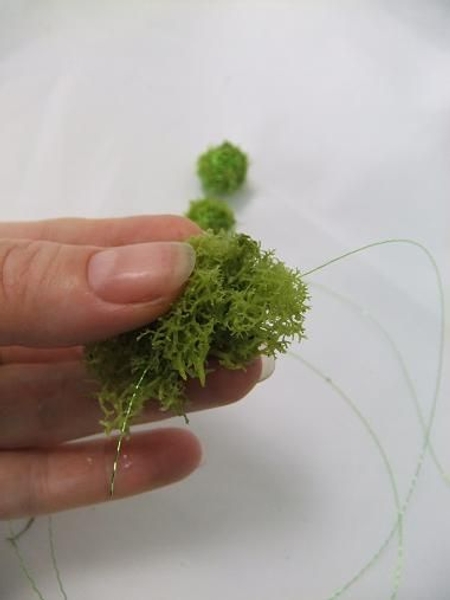 Press the end of the wire through the moss Press the end of the wire through the moss
