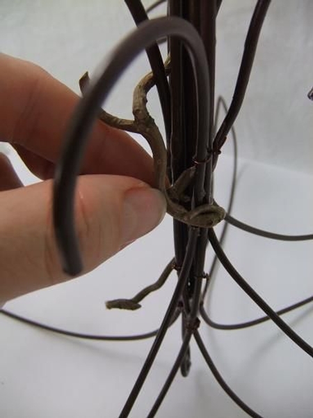 Press the twigs to catch between the wires Press the twigs to catch between the wires