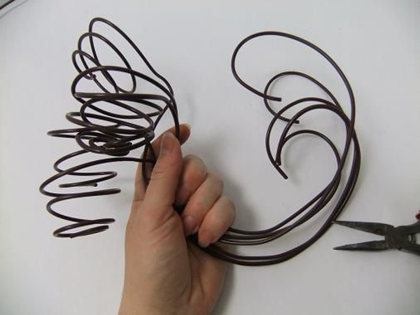 Spiral and curve a wire for each candle Spiral and curve a wire for each candle
