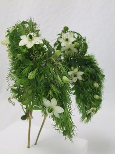 Wings made of Gyp stems, Green Trick carnations, Star of Bethlehem, Passion fruit tendrils, Jasmine foliage and String of Pearls succulents. Wings made of Gyp stems, Green Trick carnations, Star of Bethlehem, Passion fruit tendrils, Jasmine foliage and String of Pearls succulents.
